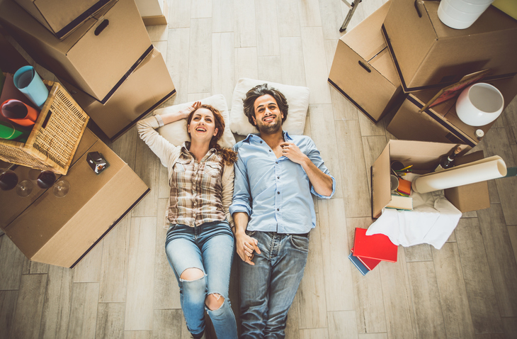 Young couple moving in into new apartment
